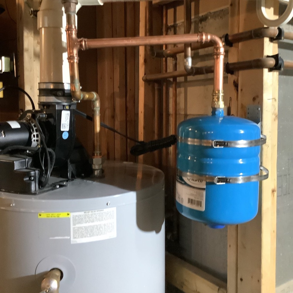 Copper water heater piping and expansion tank in a Toronto mechanical room